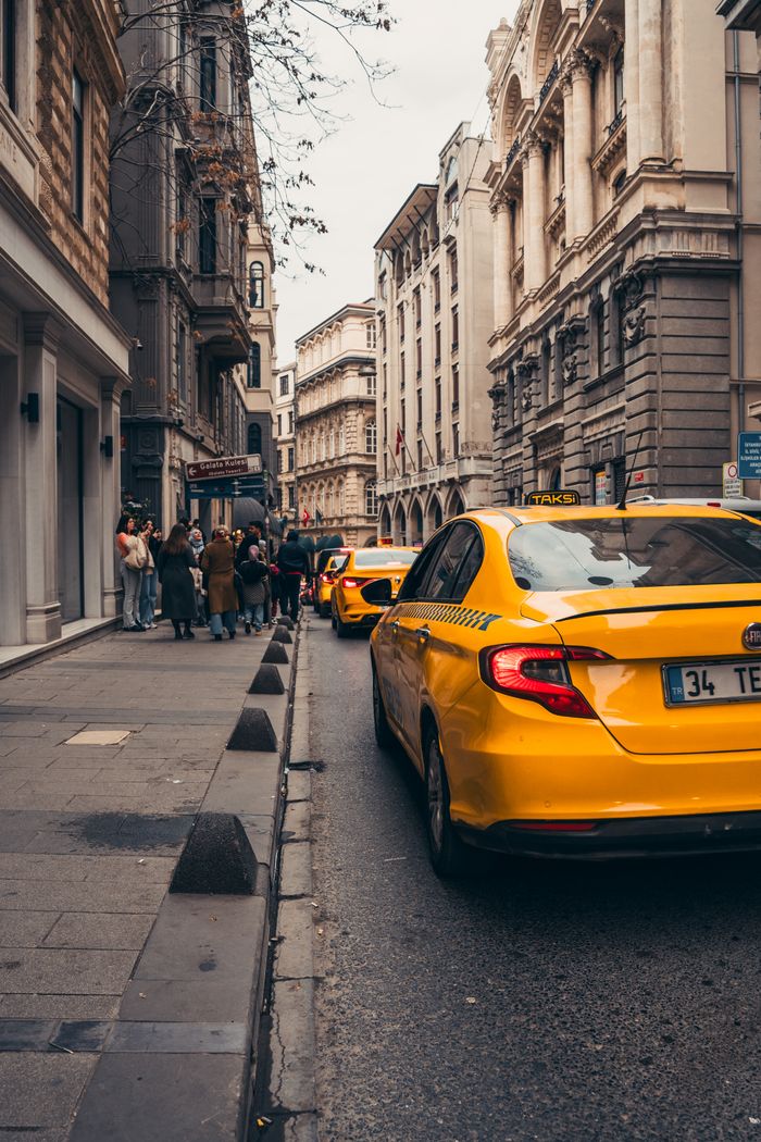 services-04 Yellow taxis line a historic street in Istanbul, embodying urban life in Turkey's bustling city.